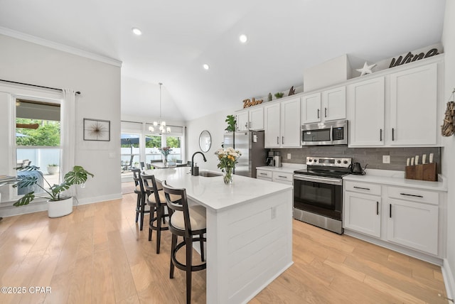 2012 Frankford Point Rd, Panama City, FL 32405 - kitchen featuring stainless steel appliances, a sink, a chandelier, backsplash, and light wood-style floors