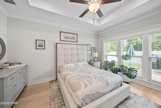 2012 Frankford Point Rd, Panama City, FL 32405 - bedroom featuring a raised ceiling, baseboards, light wood-type flooring, a ceiling fan, and ornamental molding