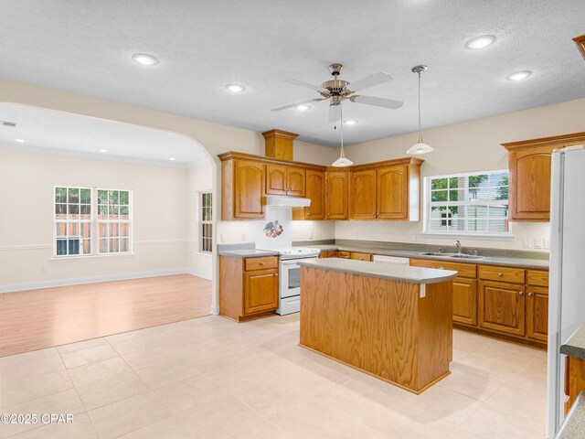 1406 New Jersey Ave, Lynn Haven, FL 32444 - kitchen with white appliances, a sink, under cabinet range hood, a kitchen island, and ceiling fan