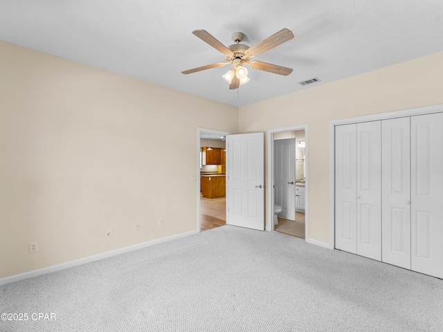 1406 New Jersey Ave, Lynn Haven, FL 32444 - unfurnished bedroom featuring carpet floors, baseboards, a closet, and ensuite bath
