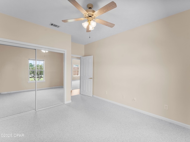 1406 New Jersey Ave, Lynn Haven, FL 32444 - unfurnished bedroom with baseboards, a closet, a ceiling fan, and carpet floors