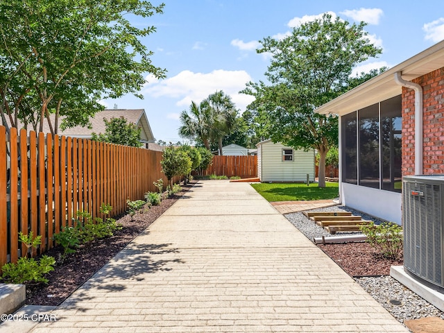 1406 New Jersey Ave, Lynn Haven, FL 32444 - view of patio / terrace featuring cooling unit, a sunroom, and an outdoor structure