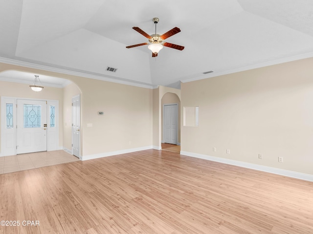 1406 New Jersey Ave, Lynn Haven, FL 32444 - unfurnished living room with arched walkways, a ceiling fan, light wood-type flooring, crown molding, and lofted ceiling