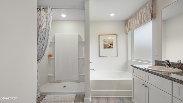 4132 Concord Blvd, Chipley, FL 32428 - full bath featuring vanity, a bath, wood finished floors, and a shower