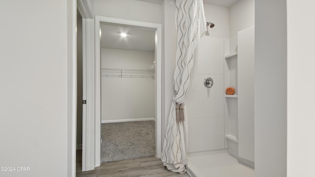 4132 Concord Blvd, Chipley, FL 32428 - bathroom featuring a shower, wood finished floors, and a walk in closet