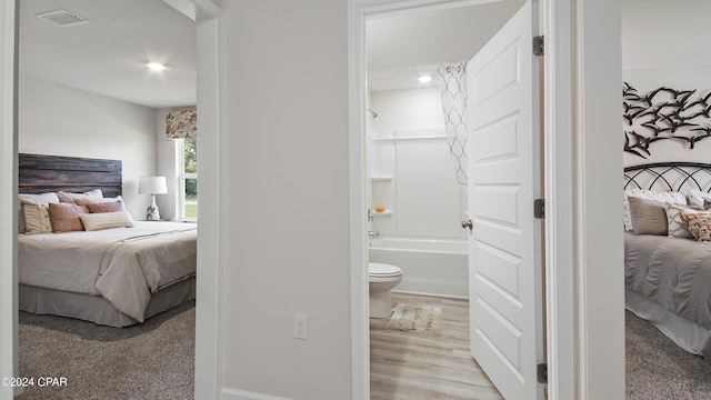 4132 Concord Blvd, Chipley, FL 32428 - bedroom featuring ensuite bath, wood finished floors, and baseboards