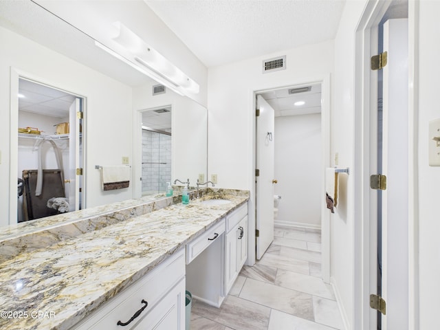 520 N Richard Jackson Blvd Unit 1301, Panama City Beach, FL 32407 - full bath featuring vanity, a shower stall, a walk in closet, marble finish flooring, and recessed lighting