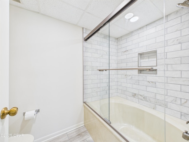 520 N Richard Jackson Blvd Unit 1301, Panama City Beach, FL 32407 - bathroom featuring shower / bath combination with glass door, toilet, baseboards, and a paneled ceiling