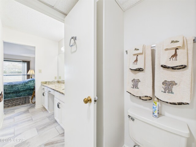 520 N Richard Jackson Blvd Unit 1301, Panama City Beach, FL 32407 - bathroom with toilet, vanity, ensuite bath, and baseboards