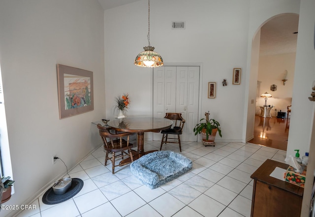 2712 Woodmere Dr, Panama City, FL 32405 - dining room with high vaulted ceiling, arched walkways, and light tile patterned flooring
