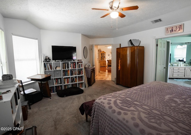 2712 Woodmere Dr, Panama City, FL 32405 - carpeted bedroom with ensuite bath, a textured ceiling, and a ceiling fan