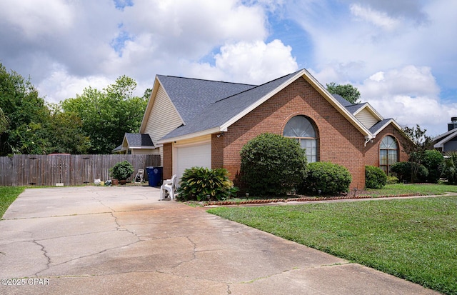 2712 Woodmere Dr, Panama City, FL 32405 - view of front of home featuring brick siding, a garage, concrete driveway, and roof with shingles