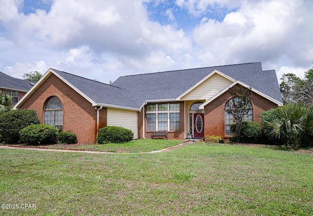 2712 Woodmere Dr, Panama City, FL 32405 - view of front of home featuring brick siding, a front lawn, and roof with shingles