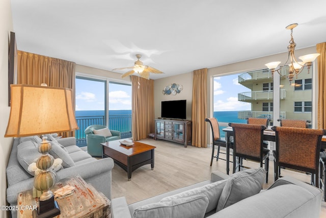 17739 Front Beach Rd Unit 1501W, Panama City Beach, FL 32413 - living room with a chandelier, ceiling fan, and light wood-type flooring