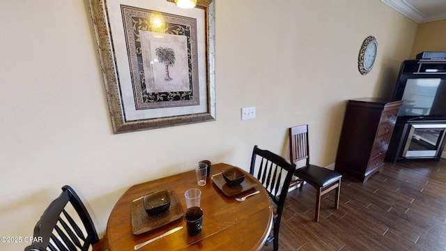 16819 Front Beach Rd Unit 903, Panama City Beach, FL 32413 - dining room featuring ornamental molding and dark wood finished floors