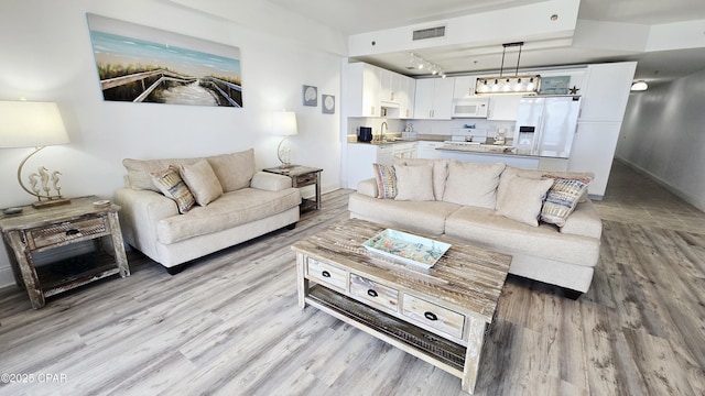 9860 S Thomas Dr Unit 1519, Panama City, FL 32408 - living room with light wood-style floors and baseboards