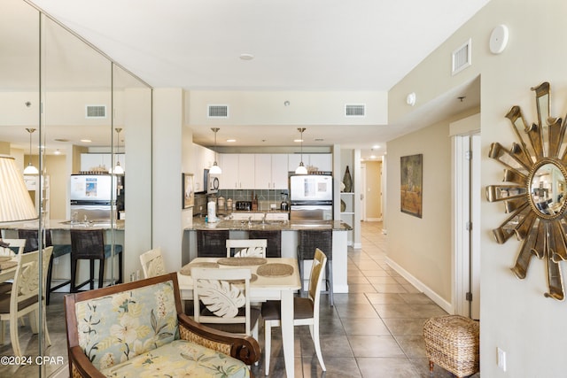 11807 Front Beach Rd Unit 1-706, Panama City Beach, FL 32407 - dining area featuring dark tile patterned floors and baseboards