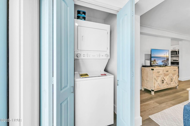 17462 Front Beach Rd Unit 11C1, Panama City Beach, FL 32413 - laundry room with stacked washer / dryer and wood finished floors