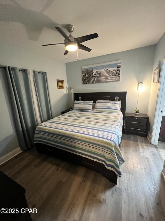 9902 S Thomas Dr Unit 237, Panama City Beach, FL 32408 - bedroom featuring wood finished floors, baseboards, and ceiling fan