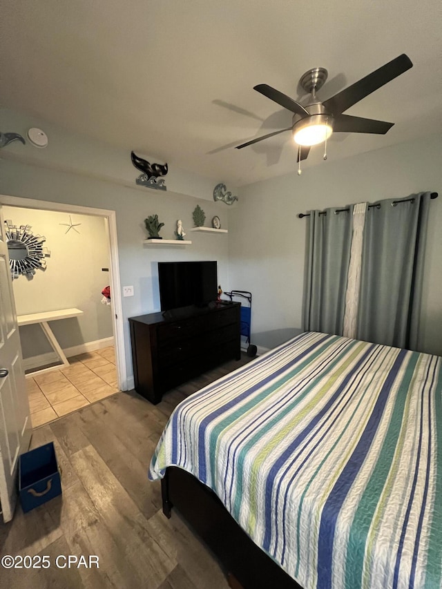 9902 S Thomas Dr Unit 237, Panama City Beach, FL 32408 - bedroom featuring a ceiling fan and wood finished floors