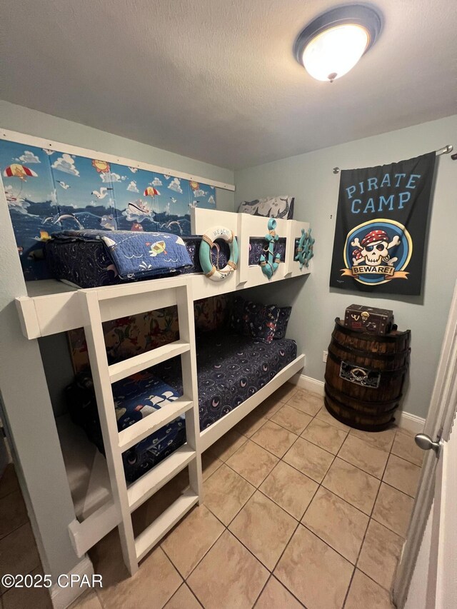 9902 S Thomas Dr Unit 237, Panama City Beach, FL 32408 - bedroom with tile patterned floors and a textured ceiling