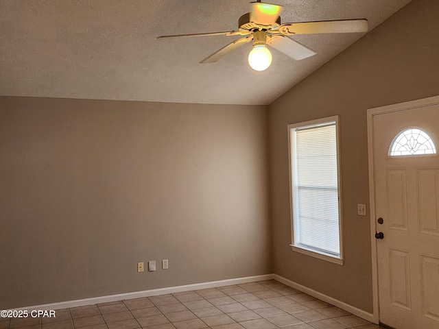5432-5434 Sunset, Panama City, FL 32408 - entryway featuring light tile patterned floors, a ceiling fan, vaulted ceiling, baseboards, and a textured ceiling