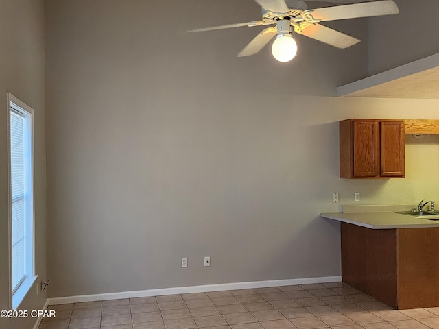 5432-5434 Sunset, Panama City, FL 32408 - kitchen with brown cabinets, light countertops, light tile patterned floors, baseboards, and a peninsula