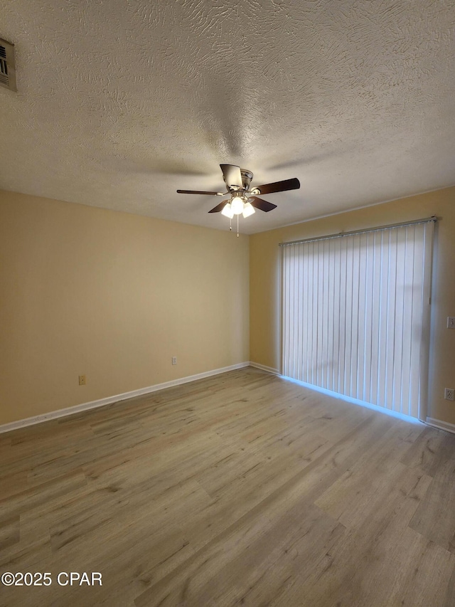 5432-5434 Sunset, Panama City, FL 32408 - unfurnished room featuring wood finished floors, baseboards, a ceiling fan, and a textured ceiling