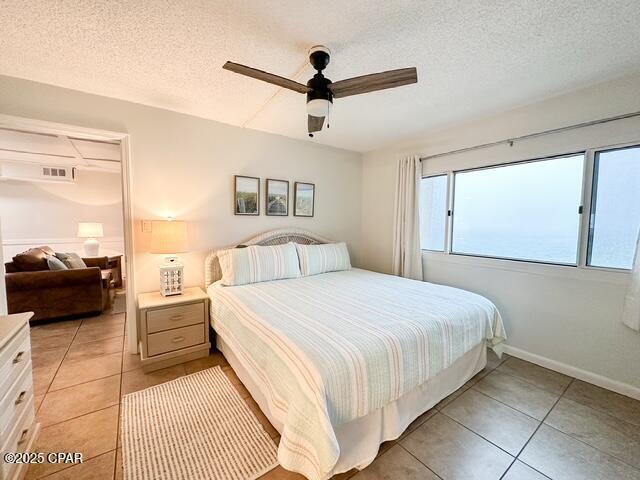 23223 Front Beach Rd Unit C3-602, Panama City Beach, FL 32413 - bedroom with light tile patterned floors, a textured ceiling, and a ceiling fan