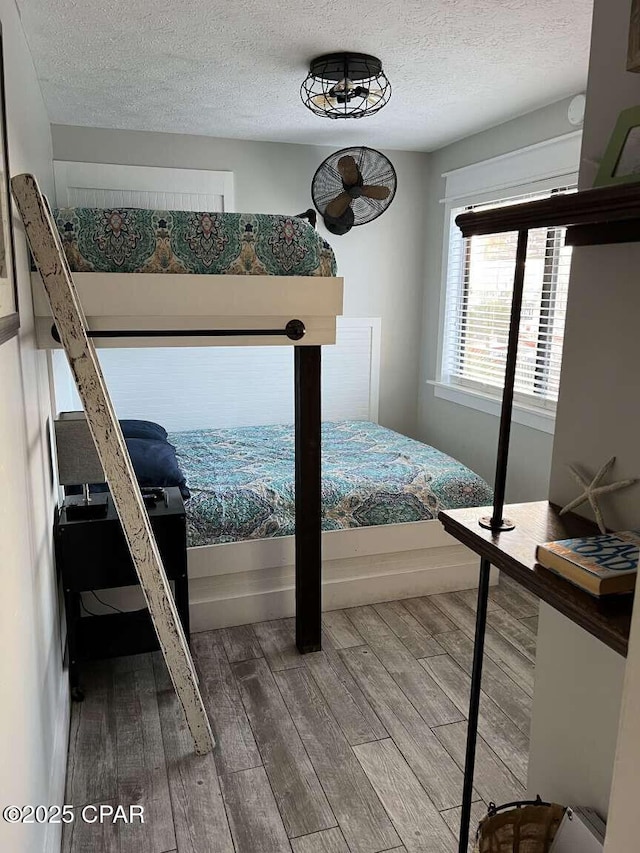 17214 Front Beach Rd Unit G-4, Panama City Beach, FL 32413 - bedroom with wood finished floors and a textured ceiling