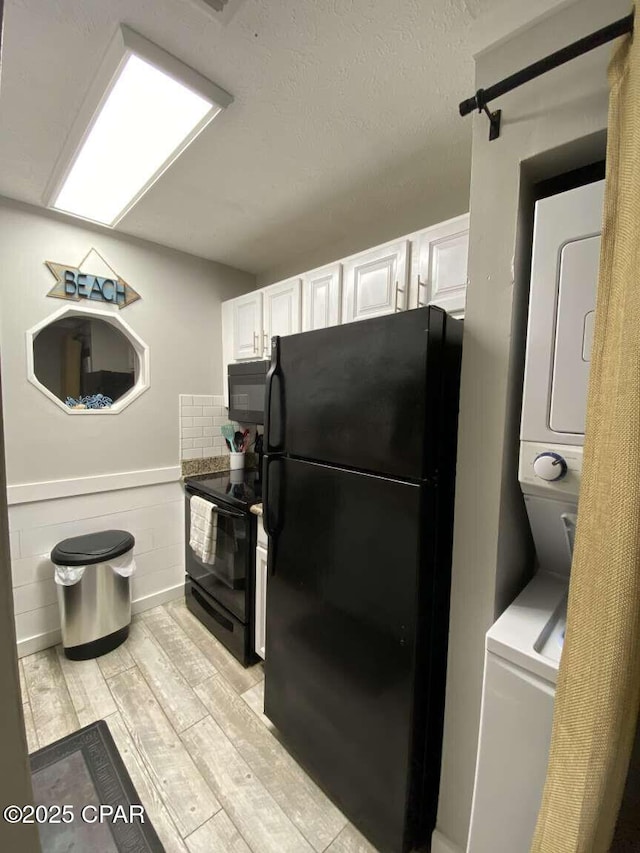 17214 Front Beach Rd Unit G-4, Panama City Beach, FL 32413 - kitchen with black appliances, white cabinets, and light wood-style flooring