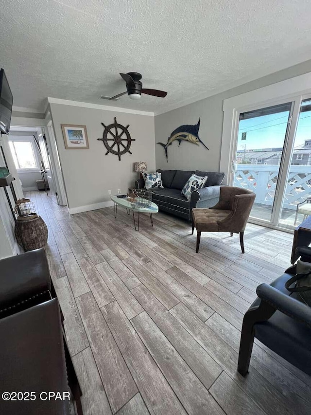 17214 Front Beach Rd Unit G-4, Panama City Beach, FL 32413 - living area featuring light wood finished floors, ceiling fan, a textured ceiling, and ornamental molding