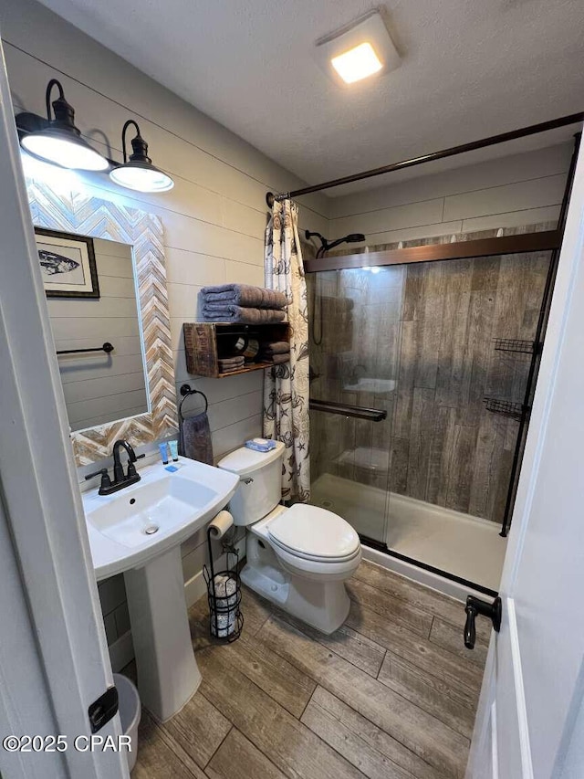 17214 Front Beach Rd Unit G-4, Panama City Beach, FL 32413 - full bath with toilet, a shower stall, and wood finished floors