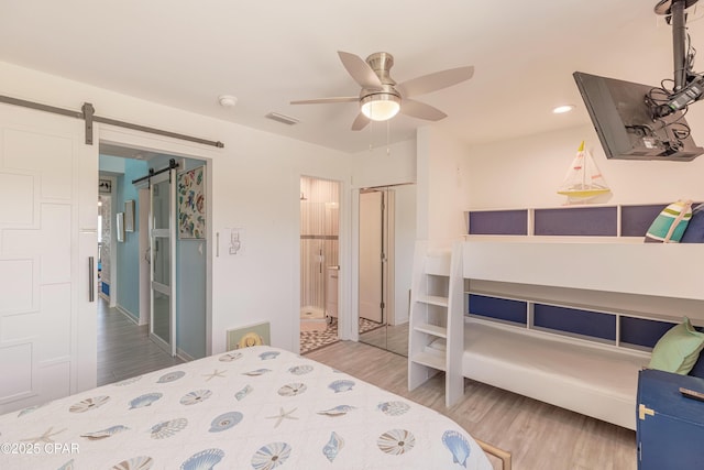 17735 Front Beach Rd Unit 2, Panama City Beach, FL 32413 - bedroom featuring wood finished floors, a barn door, and ceiling fan