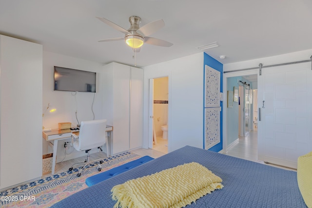 17735 Front Beach Rd Unit 2, Panama City Beach, FL 32413 - bedroom with a barn door, ensuite bathroom, an office area, baseboards, and a ceiling fan