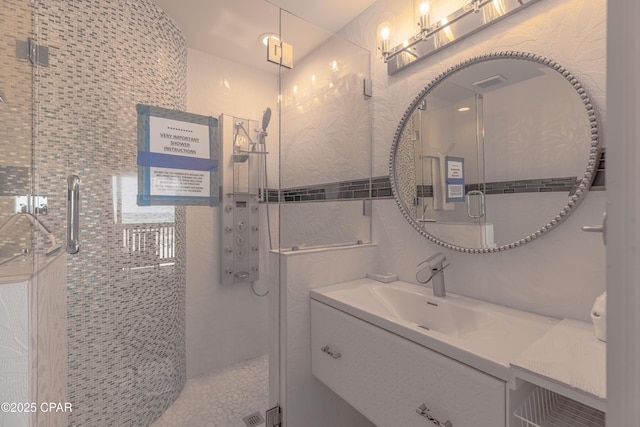 17735 Front Beach Rd Unit 2, Panama City Beach, FL 32413 - full bathroom with vanity, a shower stall, and tile walls