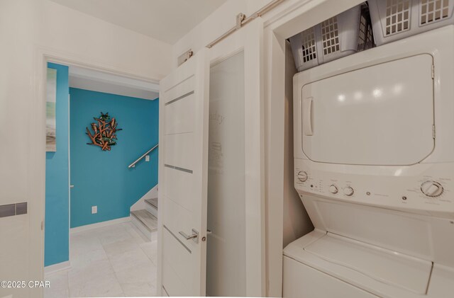 17735 Front Beach Rd Unit 2, Panama City Beach, FL 32413 - laundry room featuring stacked washer / drying machine and baseboards