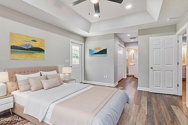 3729 E 9th St, Panama City, FL 32401 - bedroom with dark wood-type flooring, a raised ceiling, baseboards, ensuite bathroom, and recessed lighting