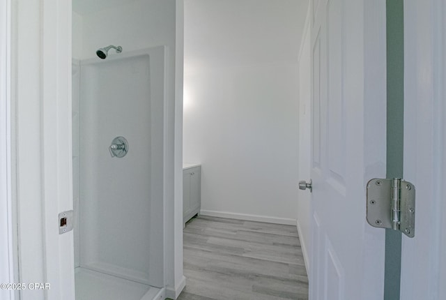 25966 George Maloy Ln, Altha, FL 32421 - bathroom with a stall shower, vanity, and wood finished floors