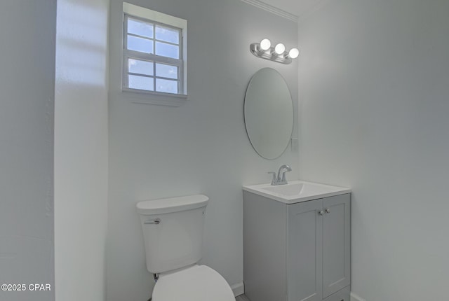 25966 George Maloy Ln, Altha, FL 32421 - bathroom featuring toilet, vanity, ornamental molding, and baseboards