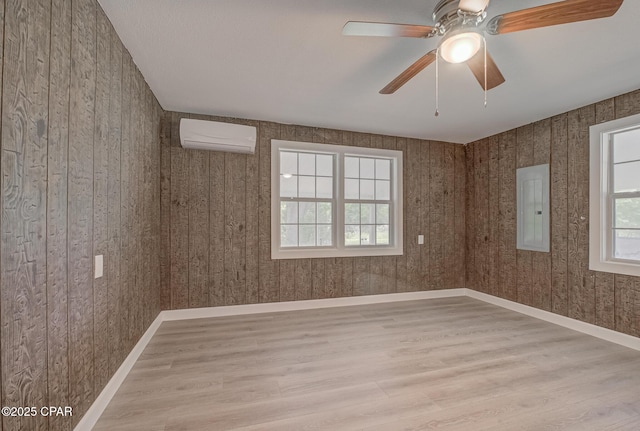 25966 George Maloy Ln, Altha, FL 32421 - unfurnished room featuring electric panel, wood finished floors, a wall mounted AC, and ceiling fan
