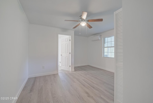 25966 George Maloy Ln, Altha, FL 32421 - empty room featuring light wood finished floors, baseboards, ceiling fan, and an AC wall unit