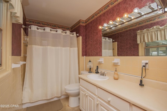 1206 Tyndall Dr, Panama City, FL 32401 - bathroom featuring tile walls, vanity, wallpapered walls, toilet, and a wainscoted wall
