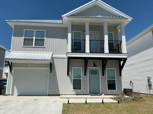305 N Gay Ave, Panama City, FL 32404 - view of front of house featuring a balcony, metal roof, an attached garage, and driveway
