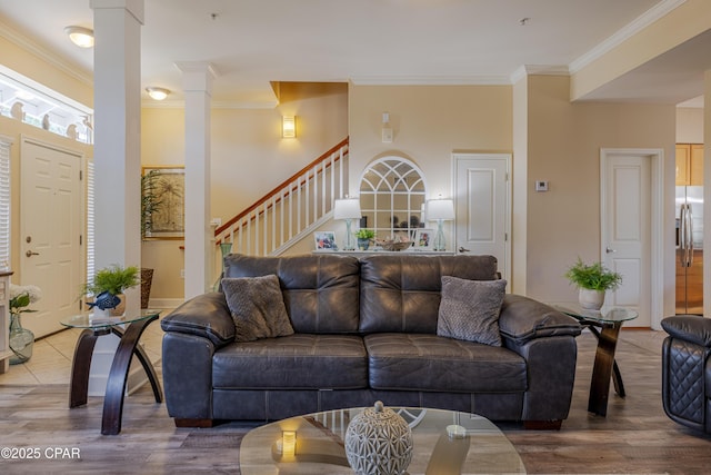 8700 Front Beach Rd Unit 8107, Panama City Beach, FL 32407 - living area featuring crown molding, decorative columns, wood finished floors, and stairs