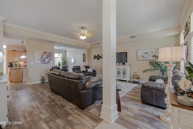 8700 Front Beach Rd Unit 8107, Panama City Beach, FL 32407 - living room featuring ornamental molding, light wood-style floors, a ceiling fan, and baseboards