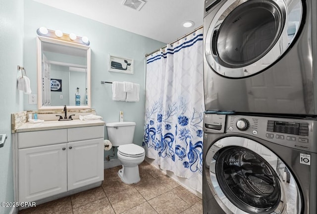 16819 Front Beach Rd Unit 2309, Panama City Beach, FL 32413 - bathroom with estacked washer and dryer, vanity, toilet, curtained shower, and tile patterned flooring