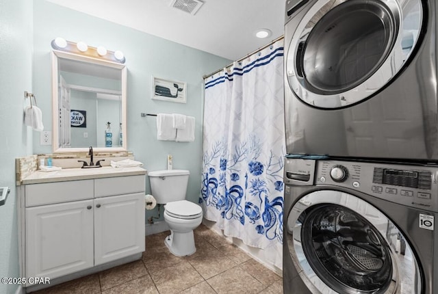 16819 Front Beach Rd Unit 2309, Panama City Beach, FL 32413 - bathroom with estacked washer and dryer, vanity, toilet, tile patterned floors, and a shower with shower curtain