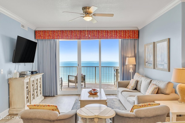 17545 Front Beach Rd Unit 2004, Panama City Beach, FL 32413 - living room with wood finished floors, a water view, ceiling fan, ornamental molding, and plenty of natural light