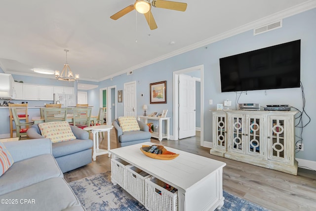 17545 Front Beach Rd Unit 2004, Panama City Beach, FL 32413 - living area with ornamental molding, ceiling fan, light wood-style floors, a chandelier, and baseboards